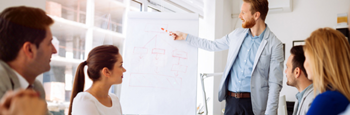 Business workers in a meeting with flipchart